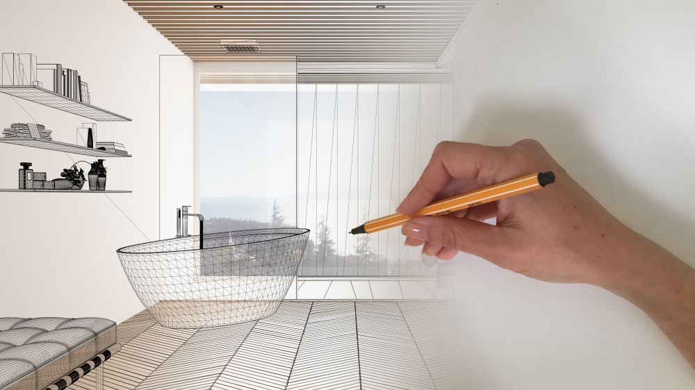 A person is drawing a bathroom with a pencil.