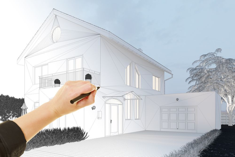 A person is drawing a house with a marker.