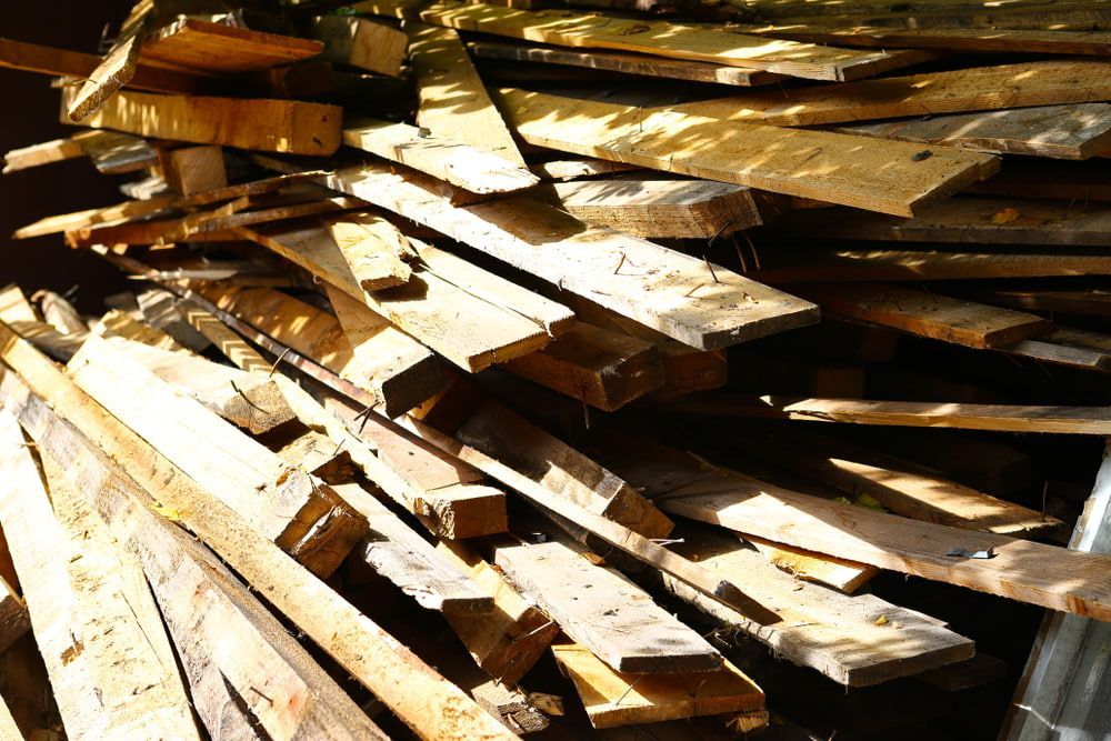 A Pile of Wood Is Stacked on Top of Each Other — Central Coast Complete Demolition & Tree Service in Woy Woy, NSW