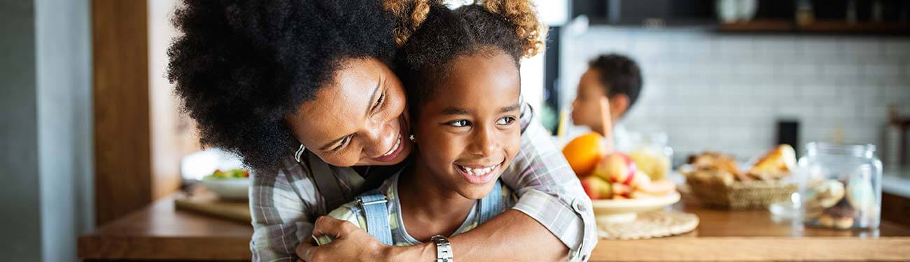 How Your Parish Can Help Families Instill the Importance of Giving Mother hugging her daughter