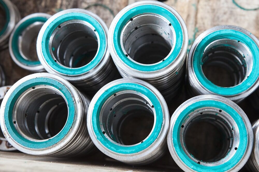 A Bunch Of Metal Cylinders With Green Seals On Them — Kset Engineering in Thornton, NSW
