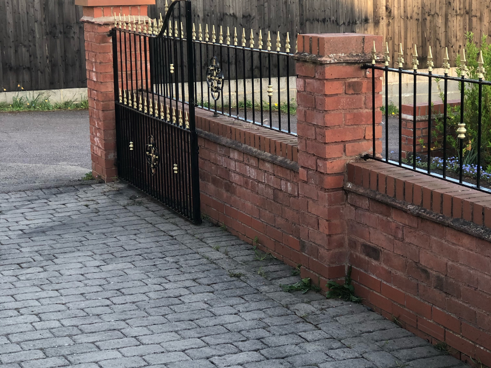 Picture of a driveway with black and gold iron metal gates and railings newly painted by Painters and Decorators Birmingham