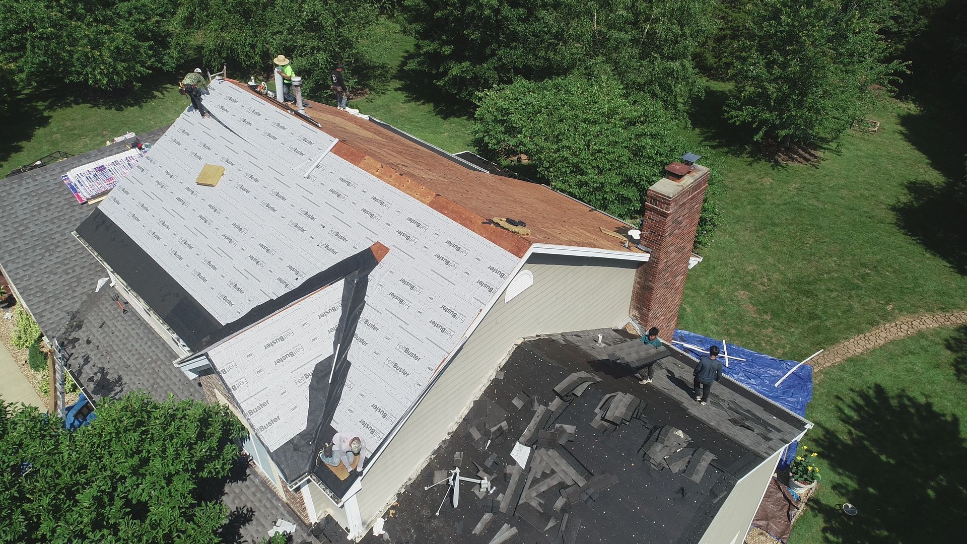 An aerial view of a roof being installed on a house.