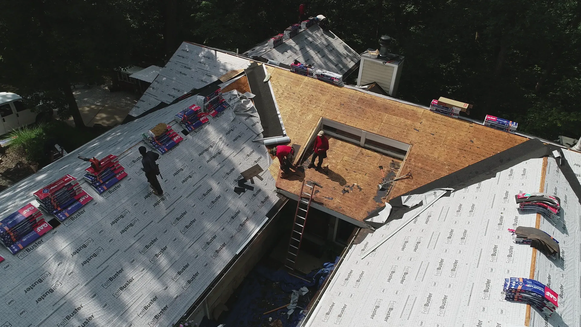 Roofer inspecting hail damage on Missouri roof