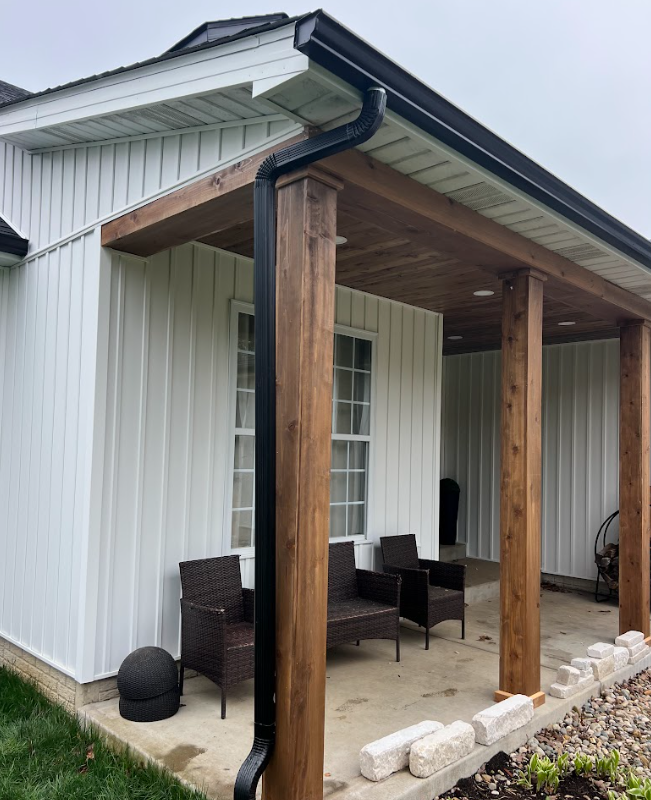 A window with arched shutters on the side of a house