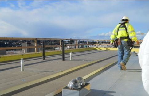 local roofer inspecting commercial roof