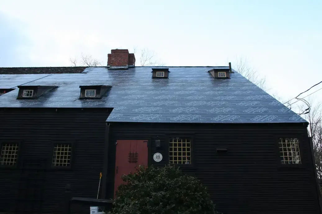 Ice and water shield installation on roof showing protective barrier membrane