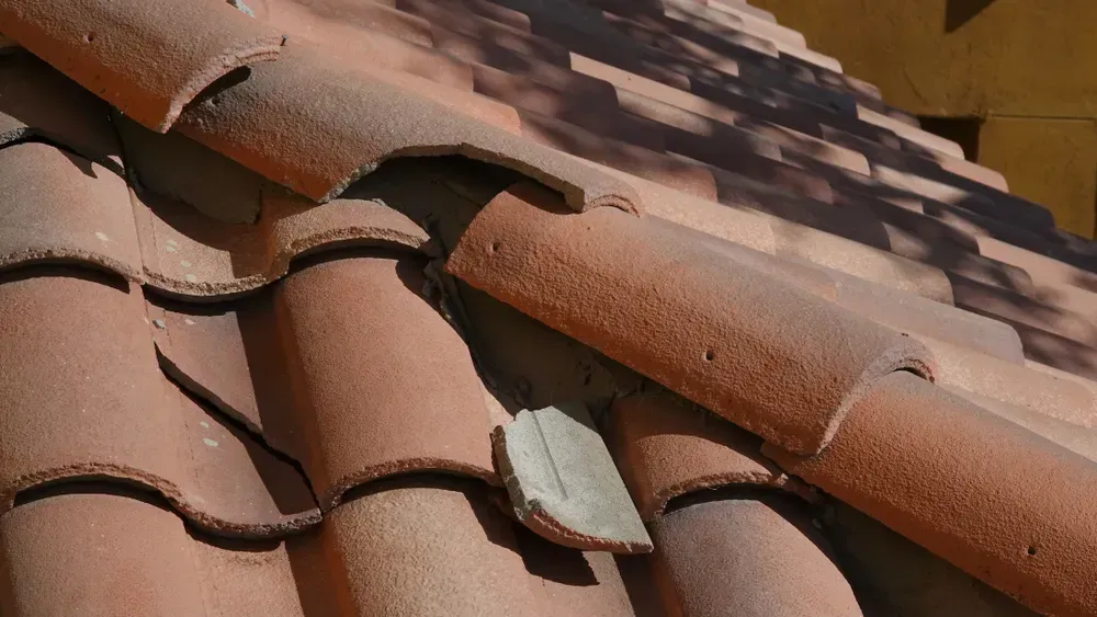 Broken ceramic roof tile in need of repair 