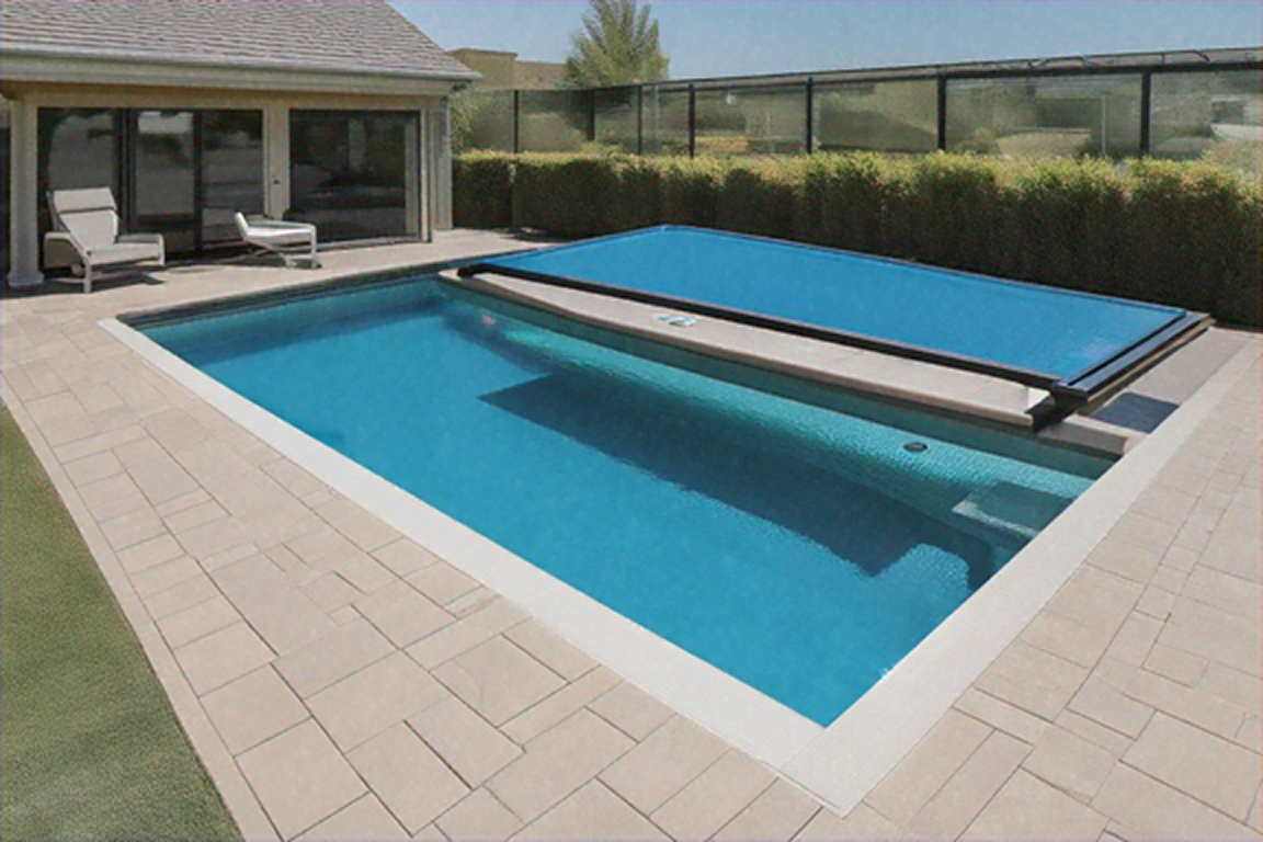 Rectangular pool with blue water and partially closed blue cover. Beige patio, house, and hedge visible.
