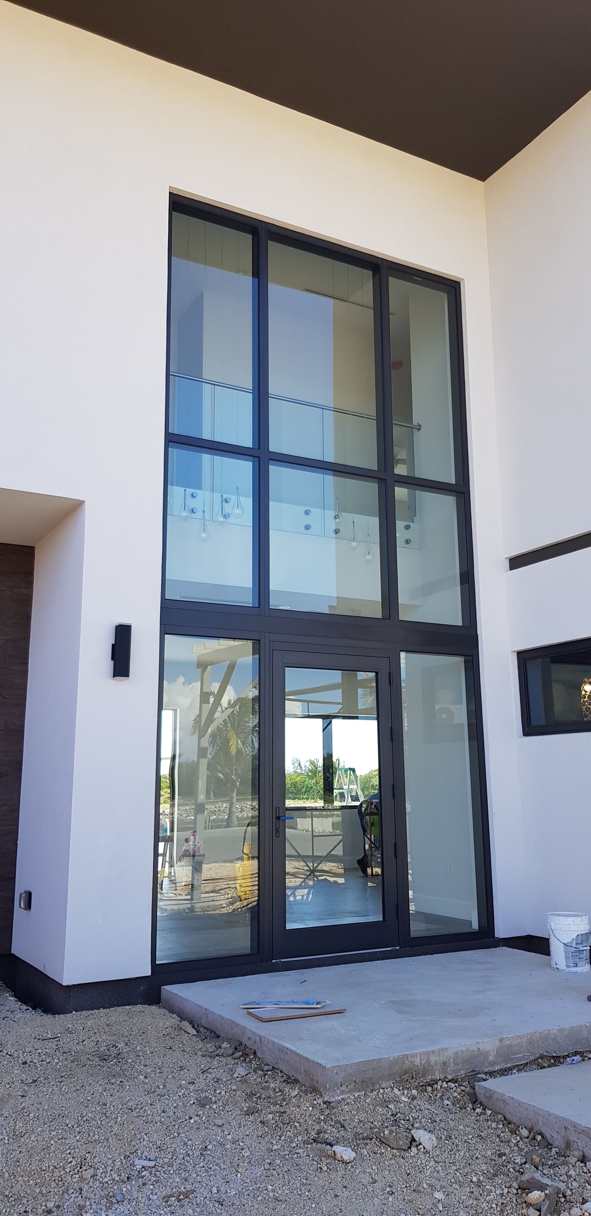 A white building with a large glass door and windows.