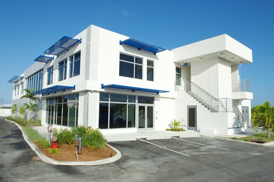 A large white building with a lot of windows and stairs