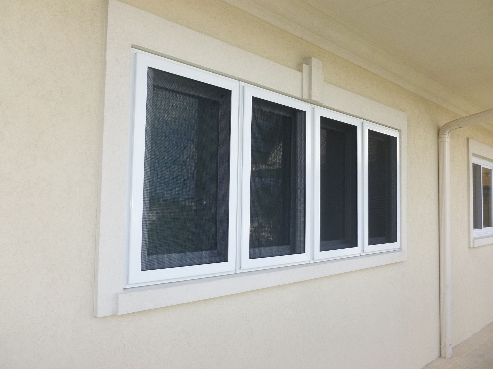 A house with four windows on the side of it.