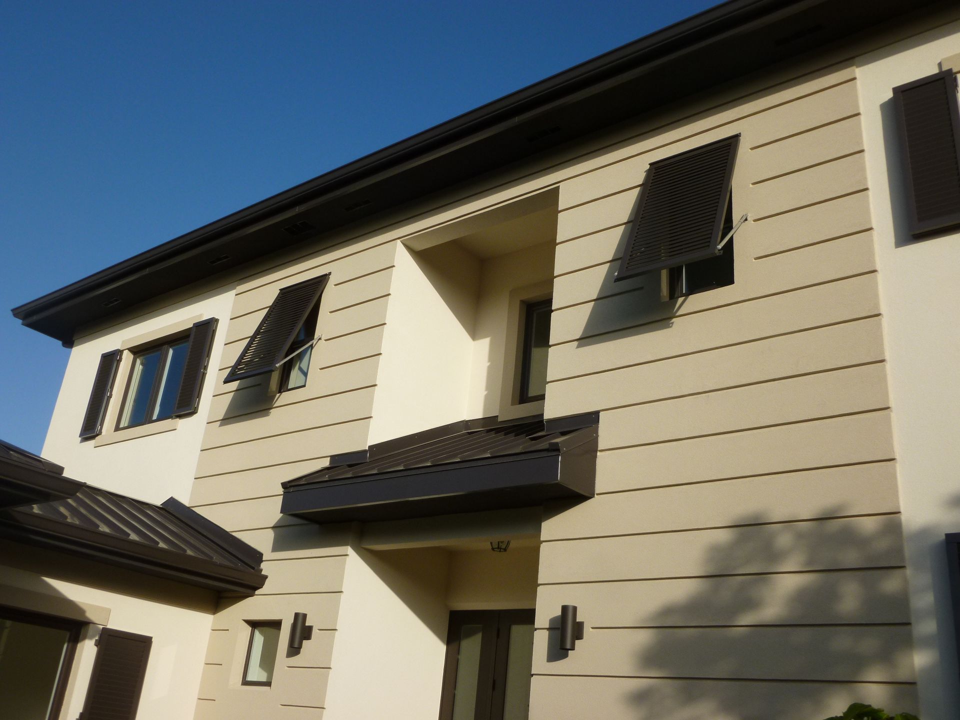 A white house with black shutters on the windows