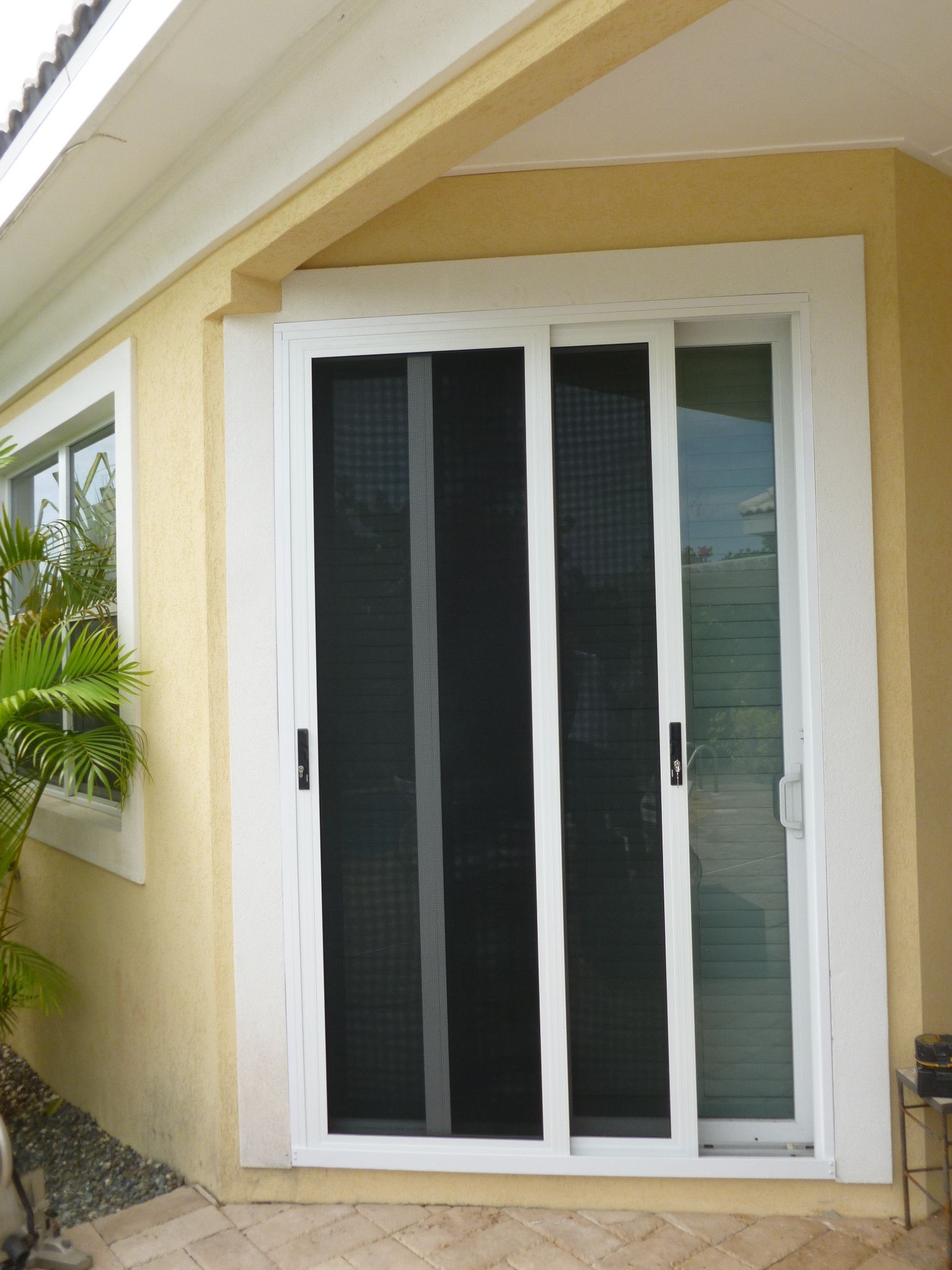 A house with a sliding screen door and a window