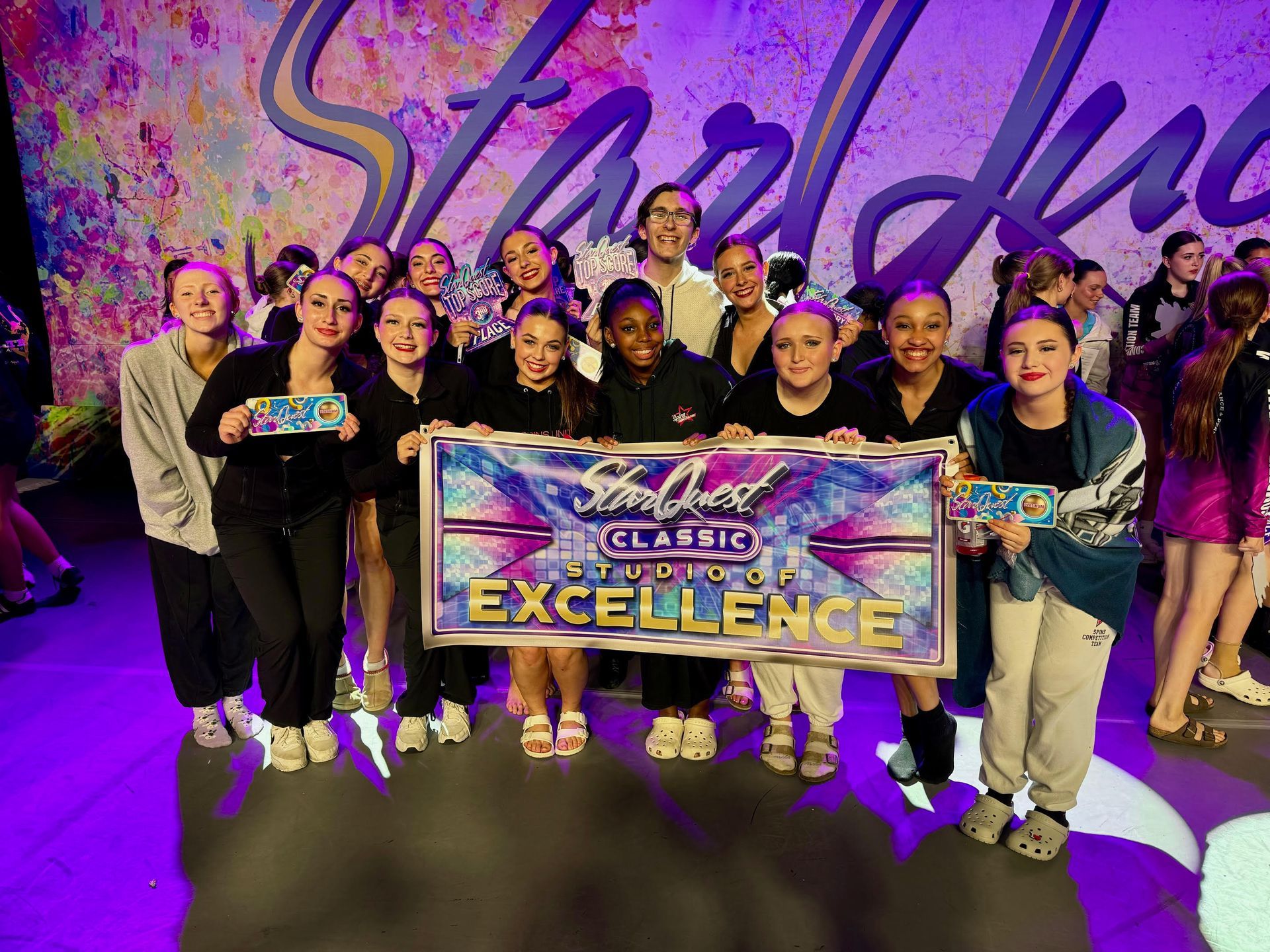 A group of young girls are posing for a picture while holding a banner that says excellence.