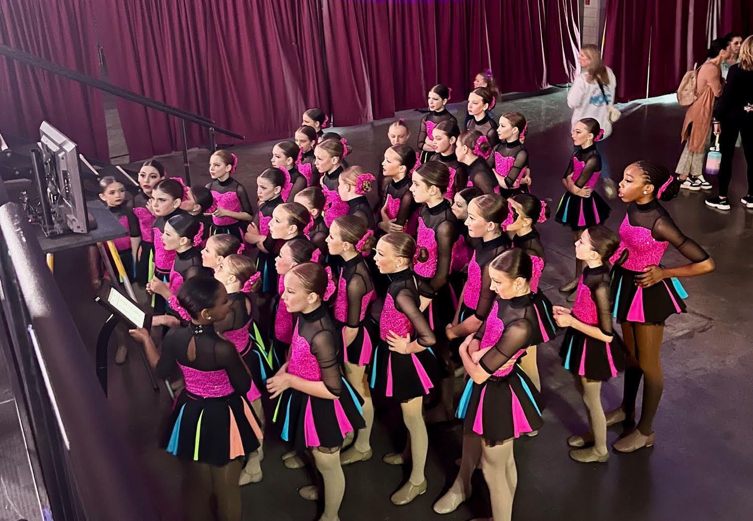 A group of young girls are standing on a stage.