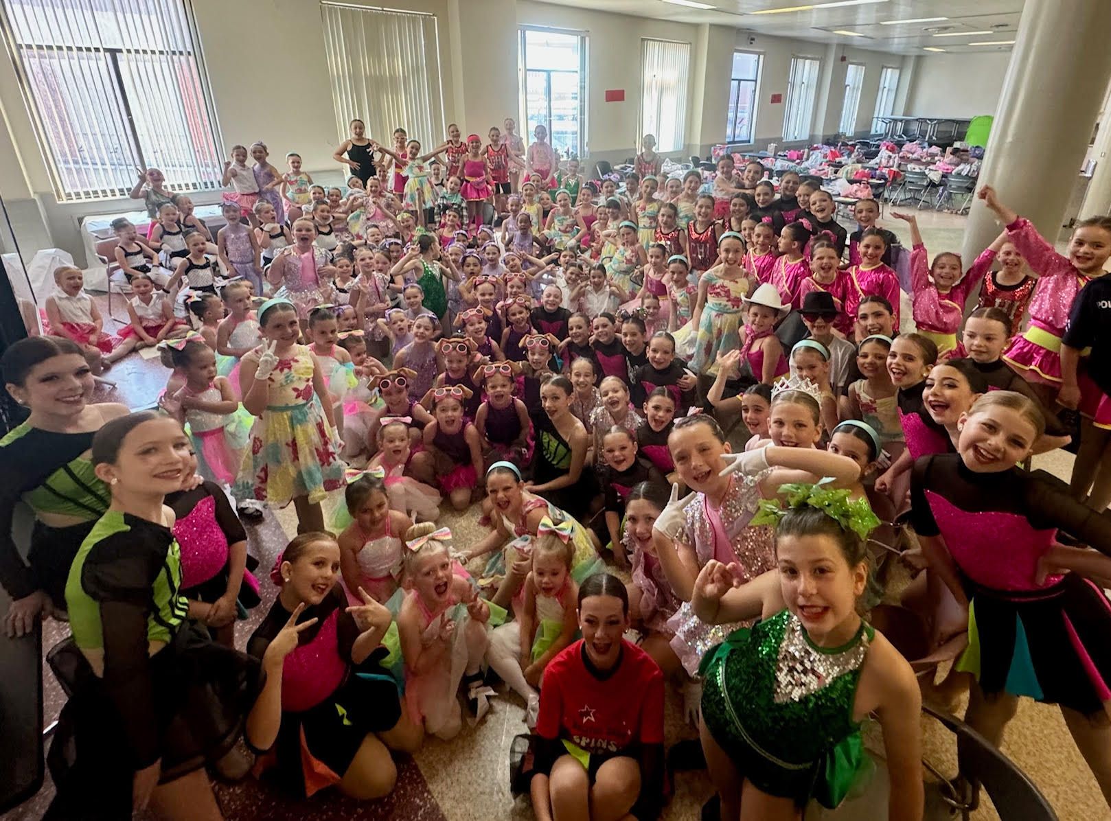 A large group of children are posing for a picture in a room.