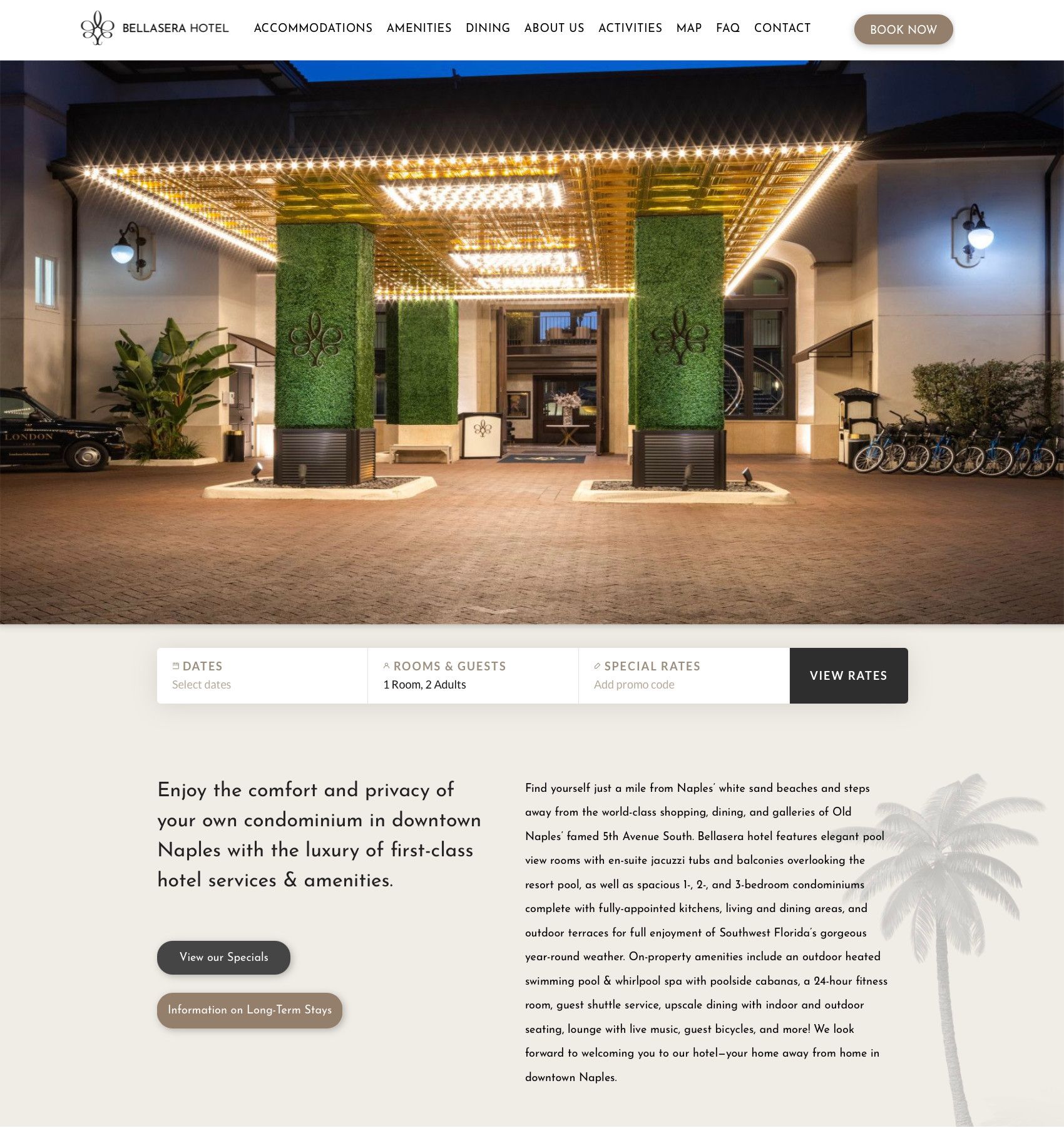 Hotel entrance with warm string lights, green columns, and a modern lobby canopy at dusk
