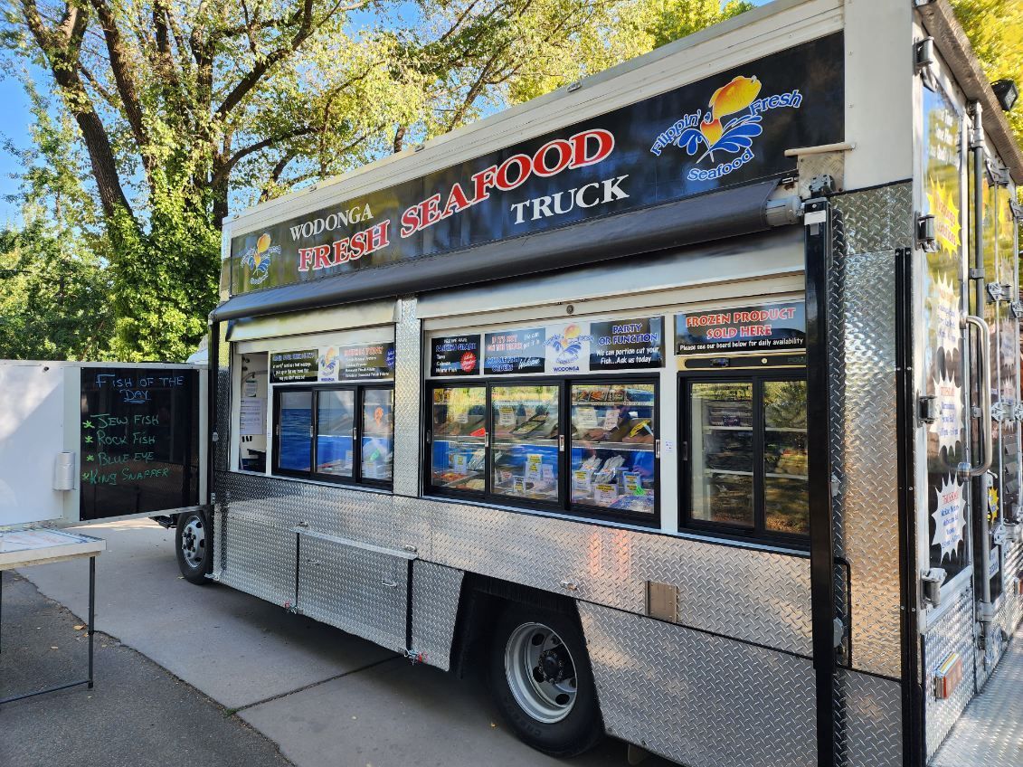 A seafood truck is parked on the side of the road.