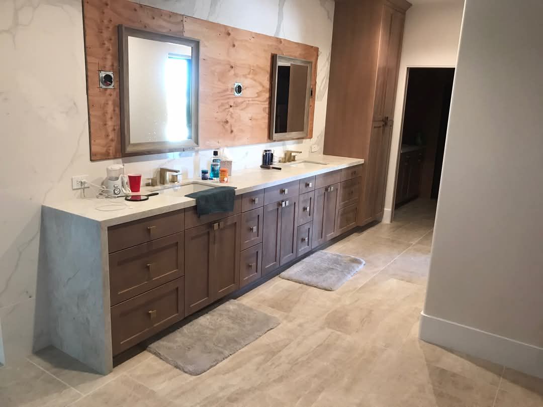 A bathroom with two sinks and two mirrors.