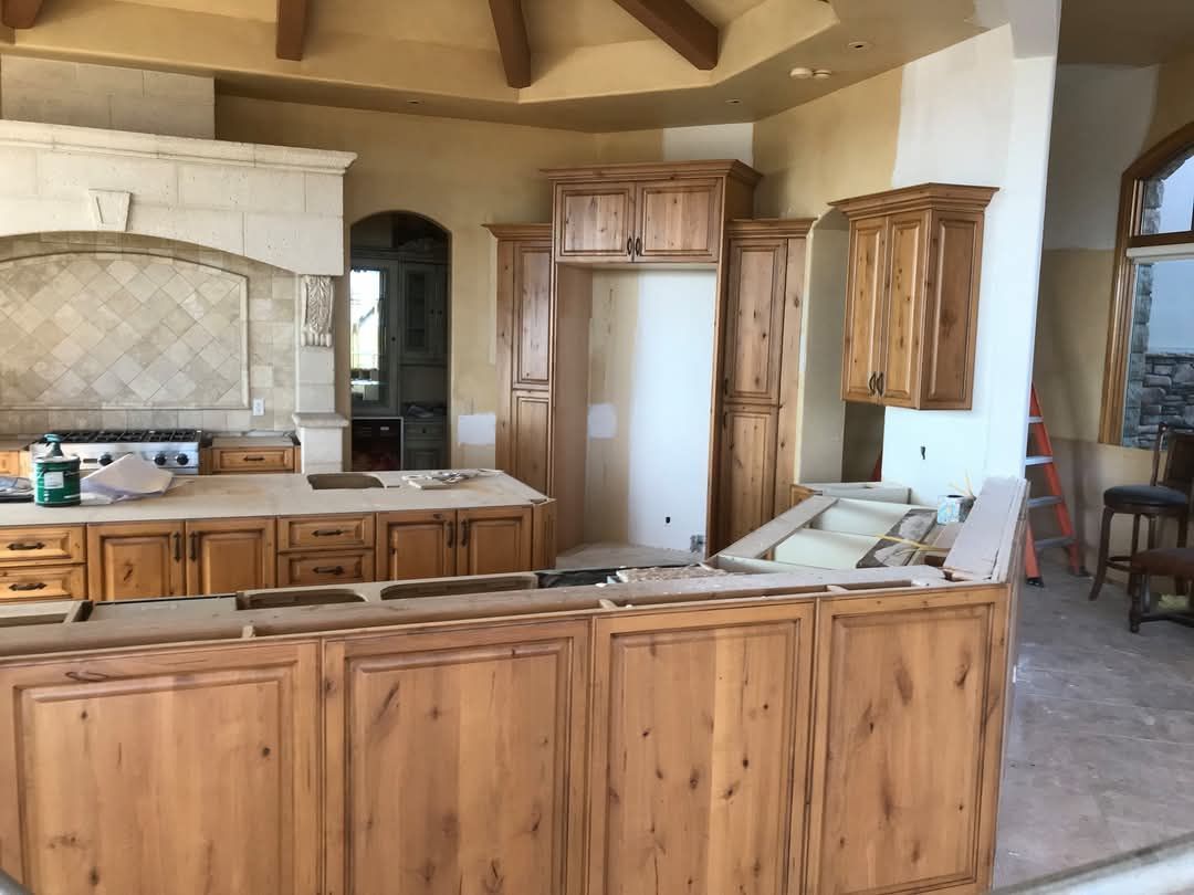 A kitchen with wooden cabinets and a large island