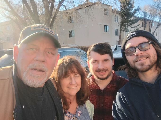 A group of people are posing for a picture in front of a building.