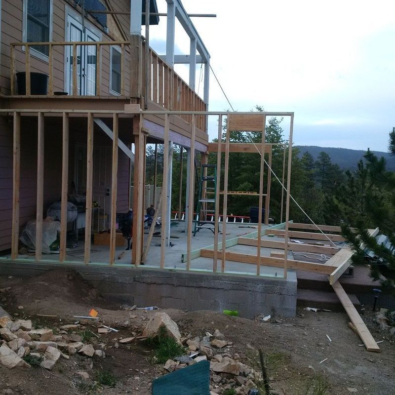 A house that is being built with a wooden deck