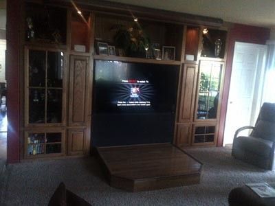 A living room with a large flat screen tv on the wall