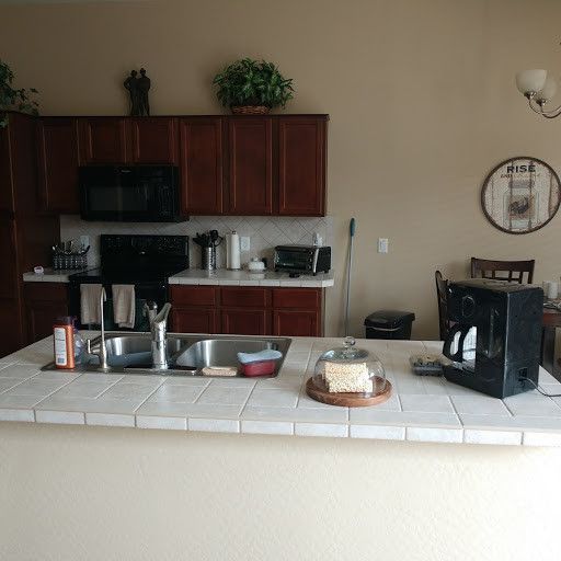 A kitchen with two sinks and a coffee maker