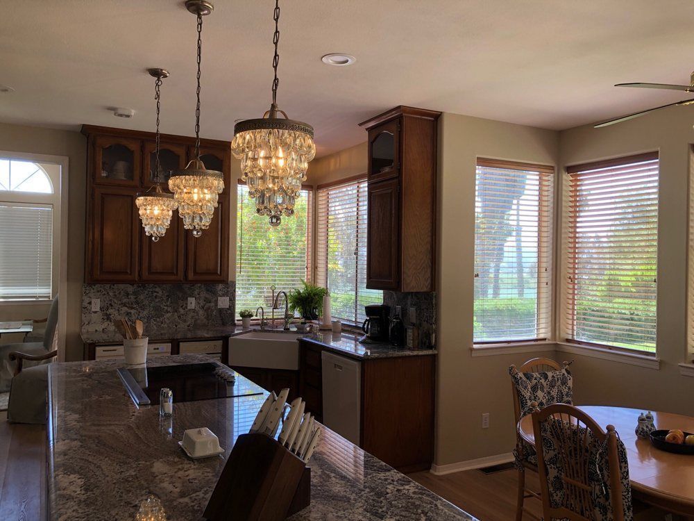 A kitchen with a dining table and chairs and a sink.