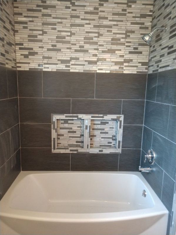 A bathroom with a bathtub and a shower.