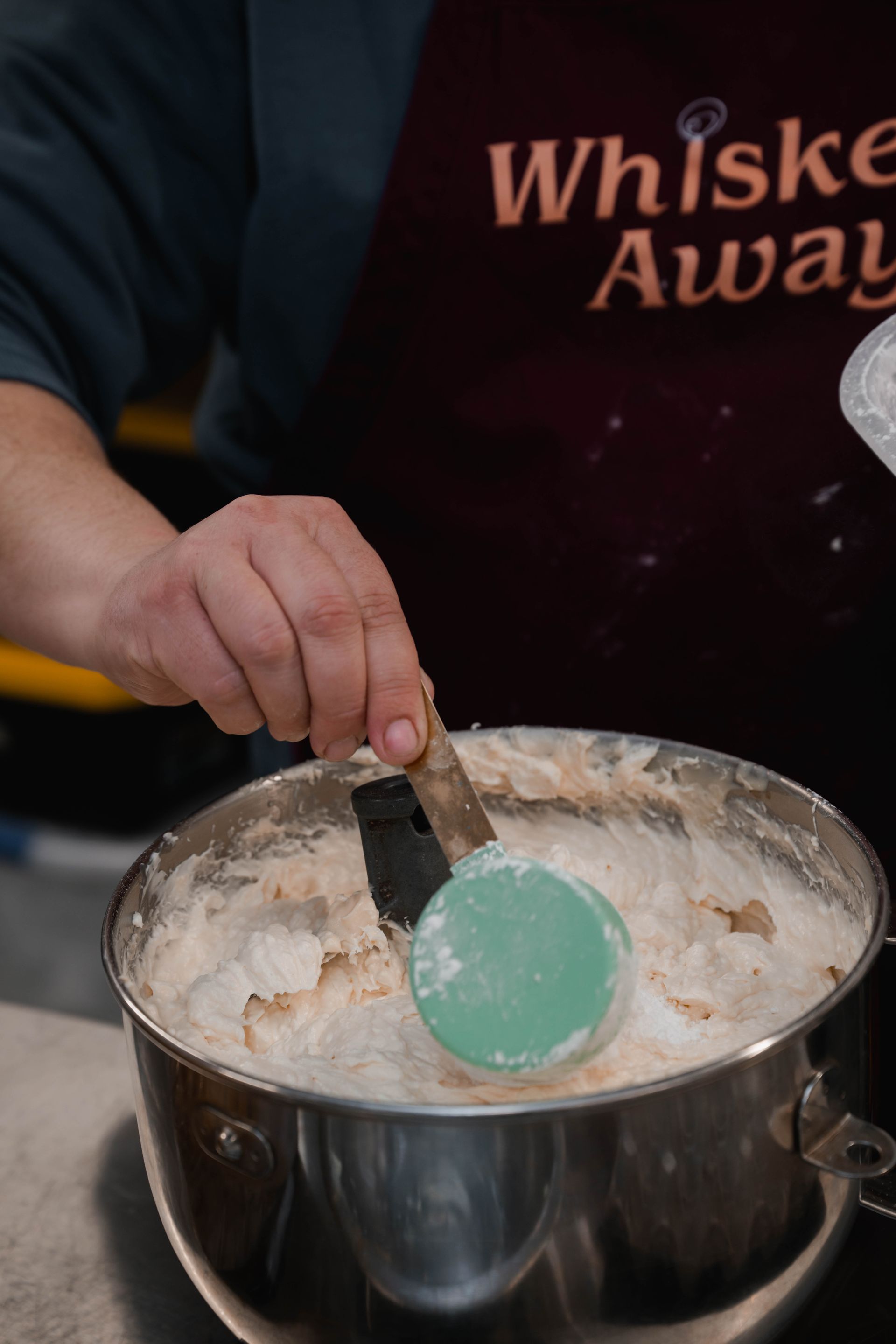 Woman cracking an egg into flour on a wooden table, preparing to bake.