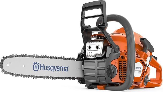 A husqvarna chainsaw is sitting on a white surface.