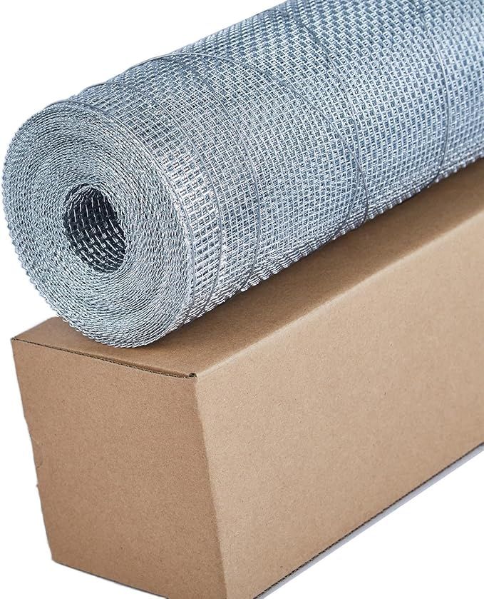 A roll of wire mesh is sitting on top of a cardboard box.