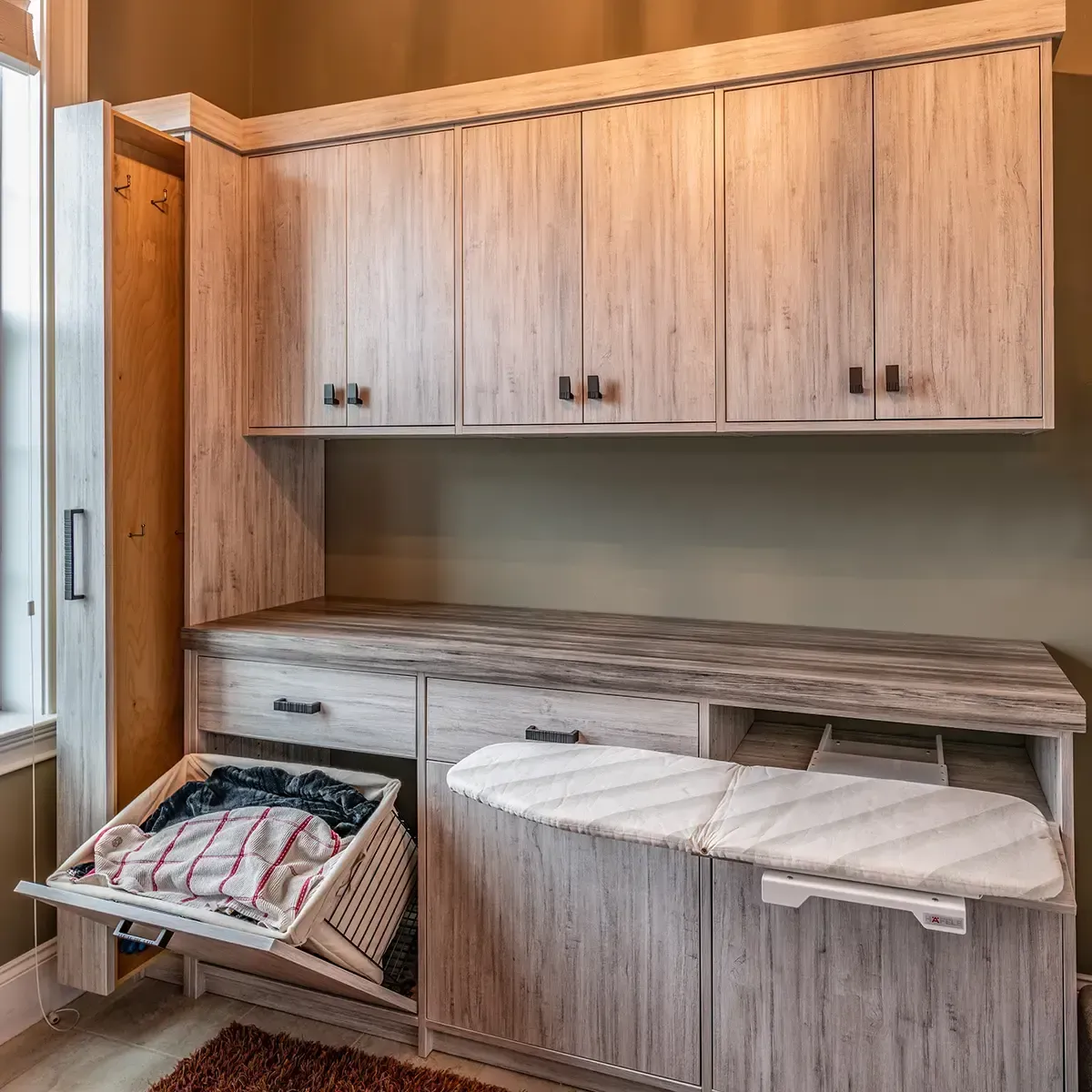 Walk-in closet with wooden shelves, clothes, luggage, and shoes.
