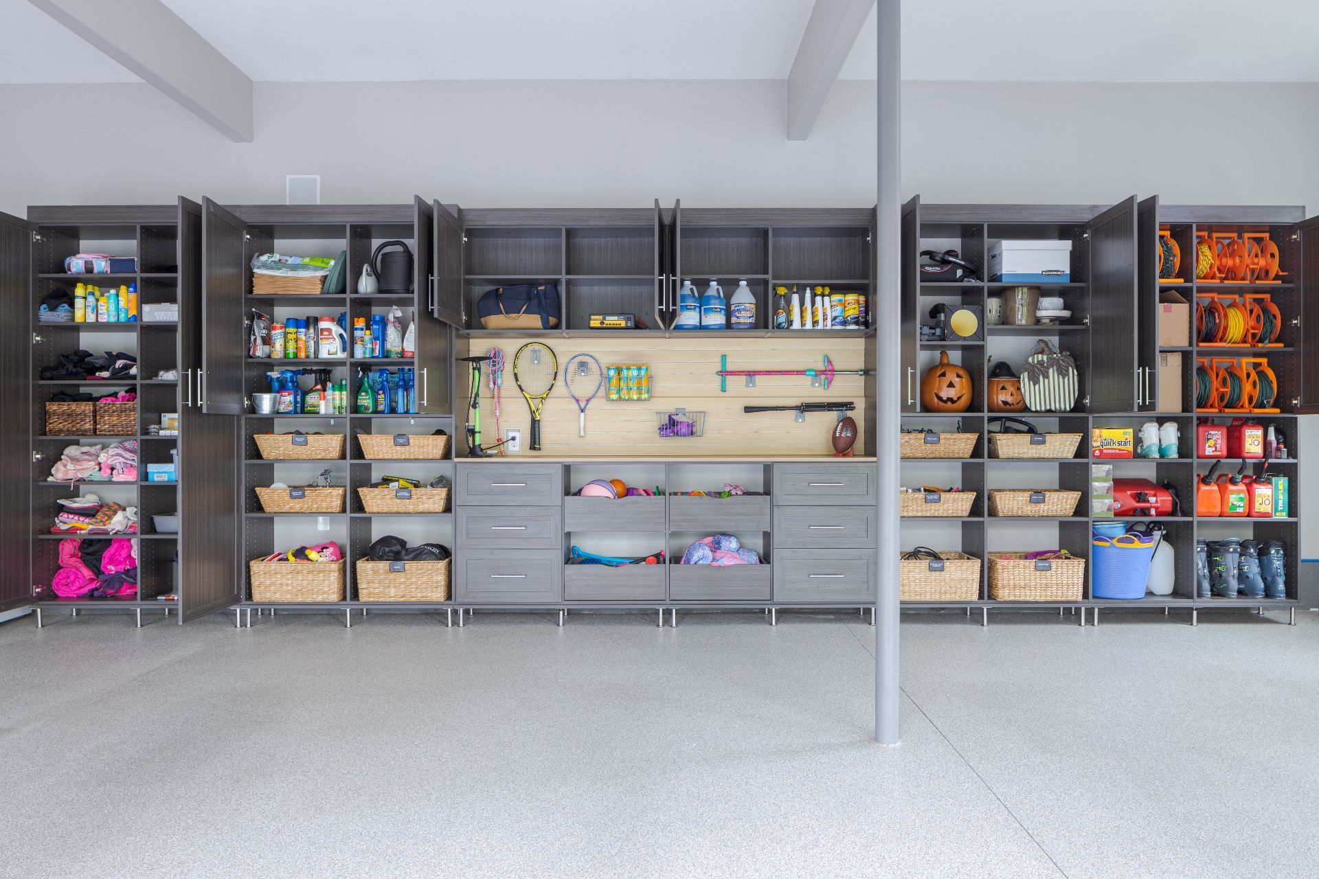 A well-organized white pantry with shelves stocked with food items, bottles, and a rotating corner storage unit.
