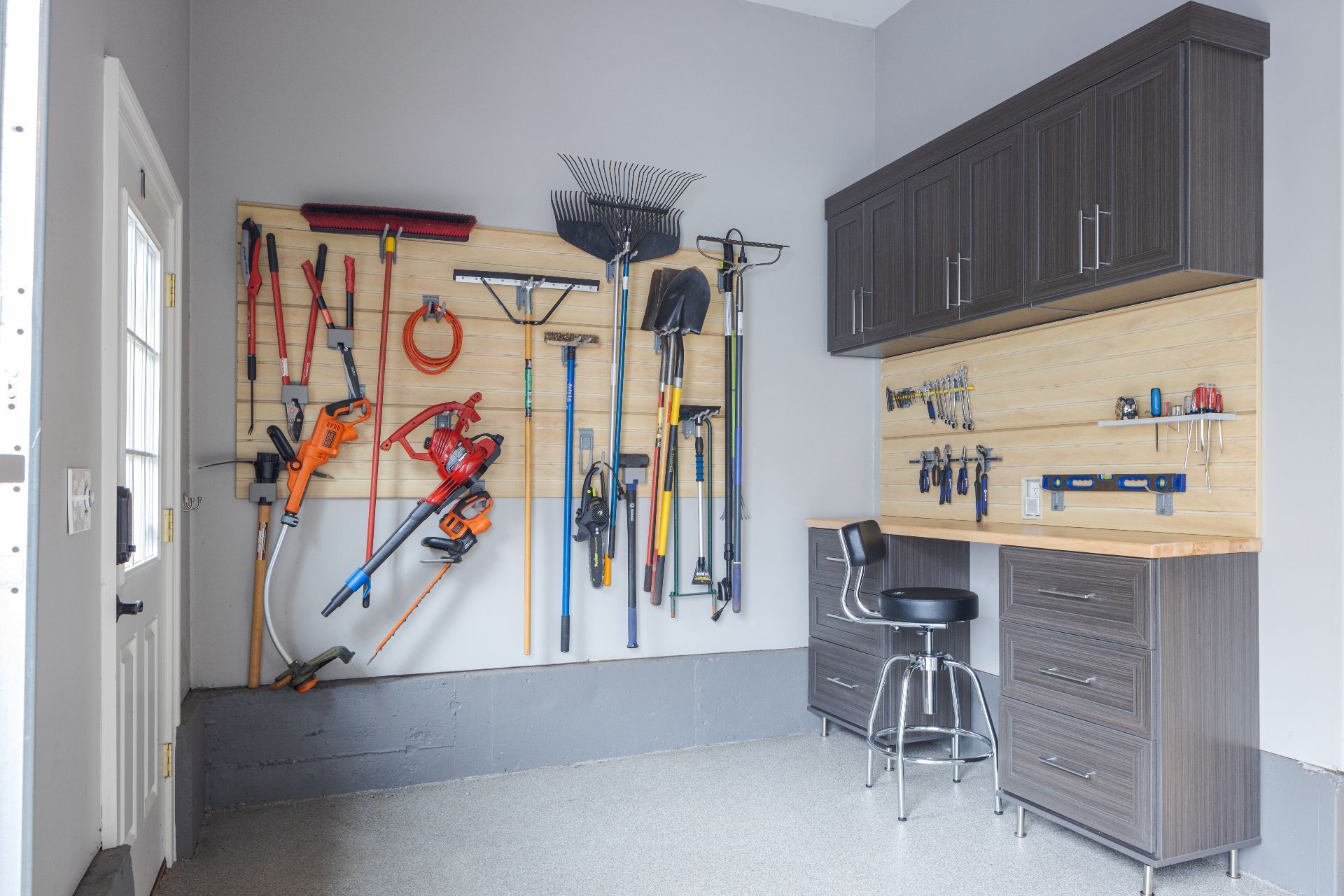 White kitchen cabinets with shelves, storing food items, wine bottles, and a red mixer, next to a wood-topped island.