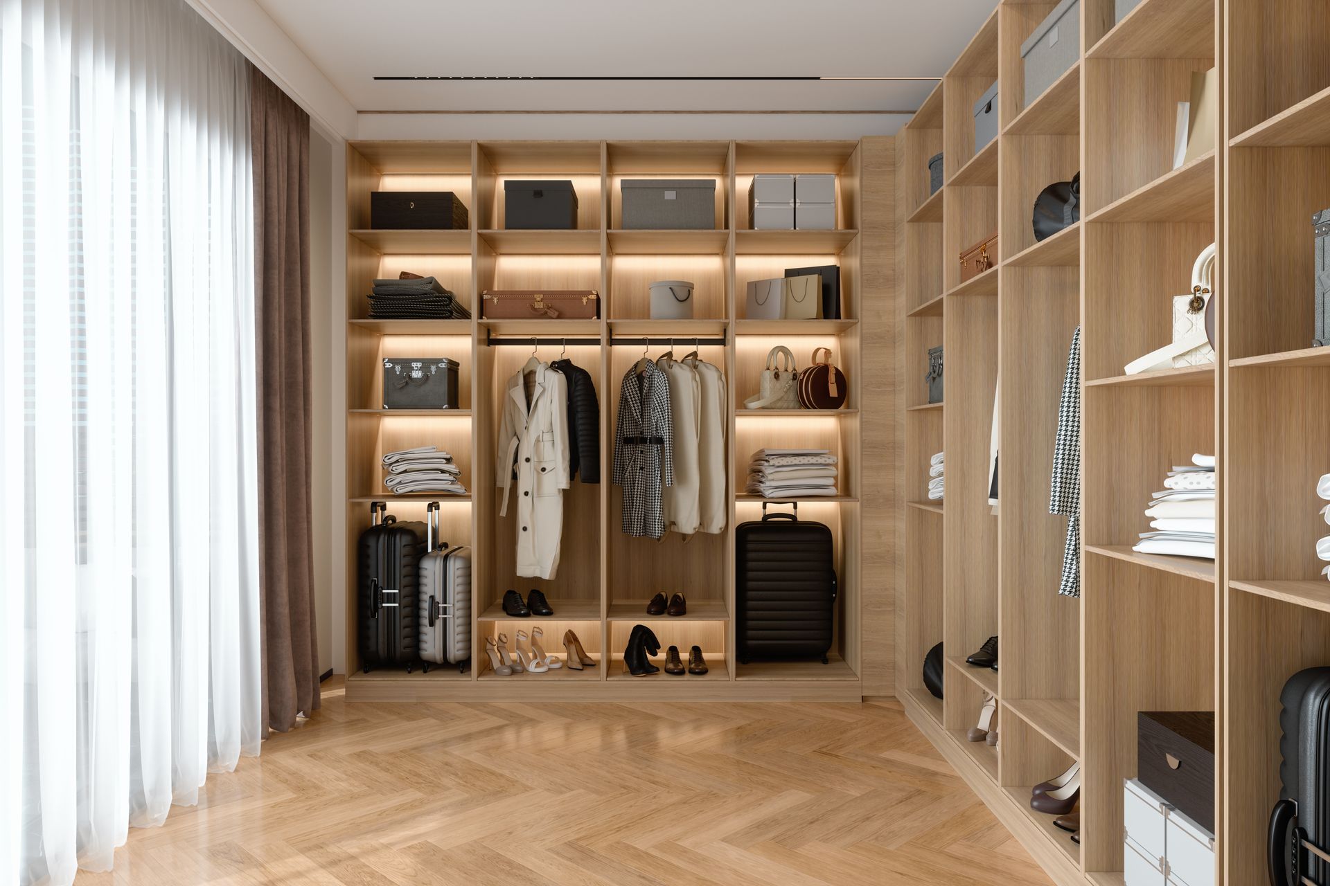 Walk-in closet with wooden shelves, clothes, luggage, and shoes.