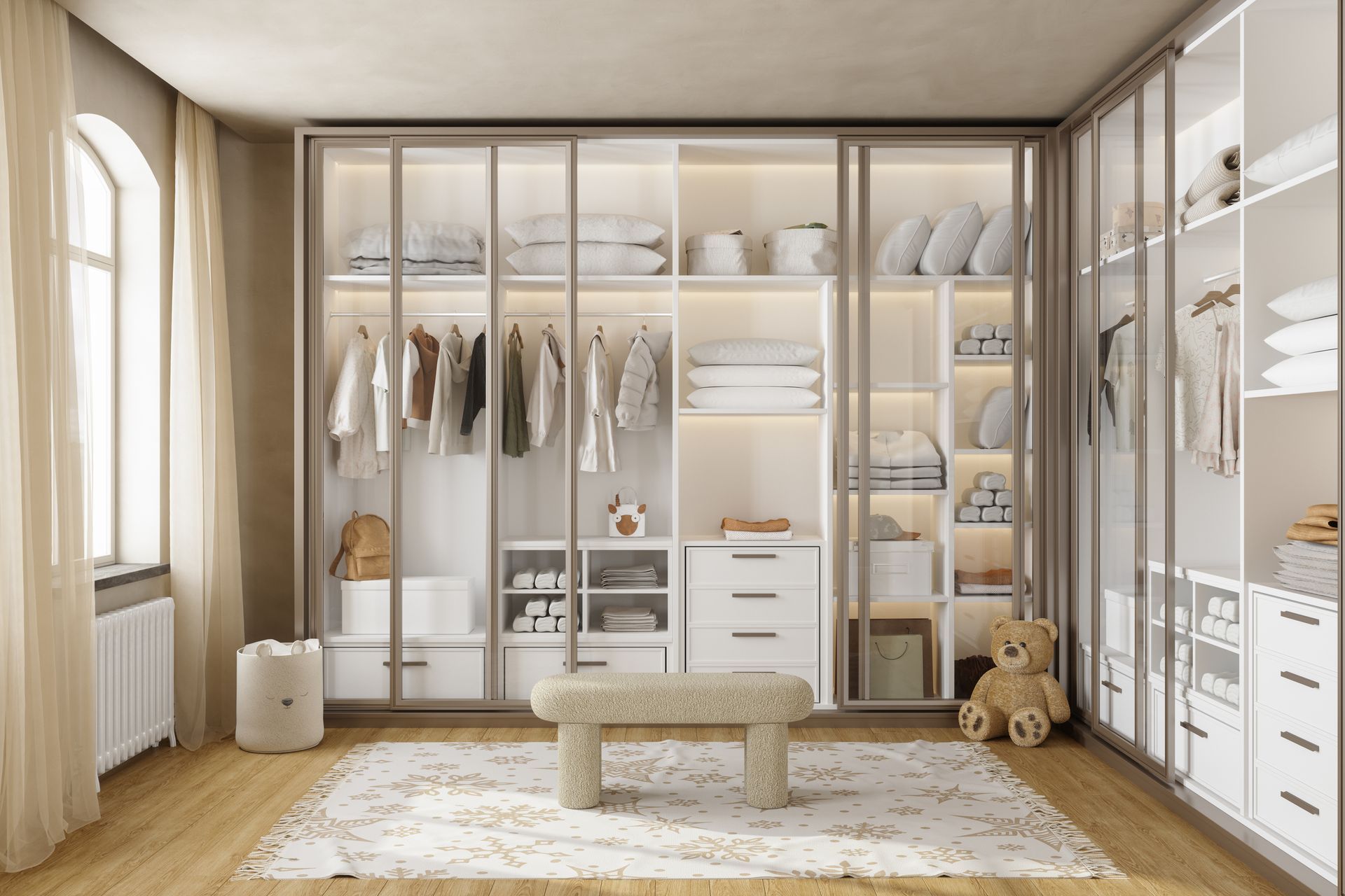 A modern, organized walk-in closet with glass-front wardrobe cabinets, a central beige bench, and a patterned area rug.