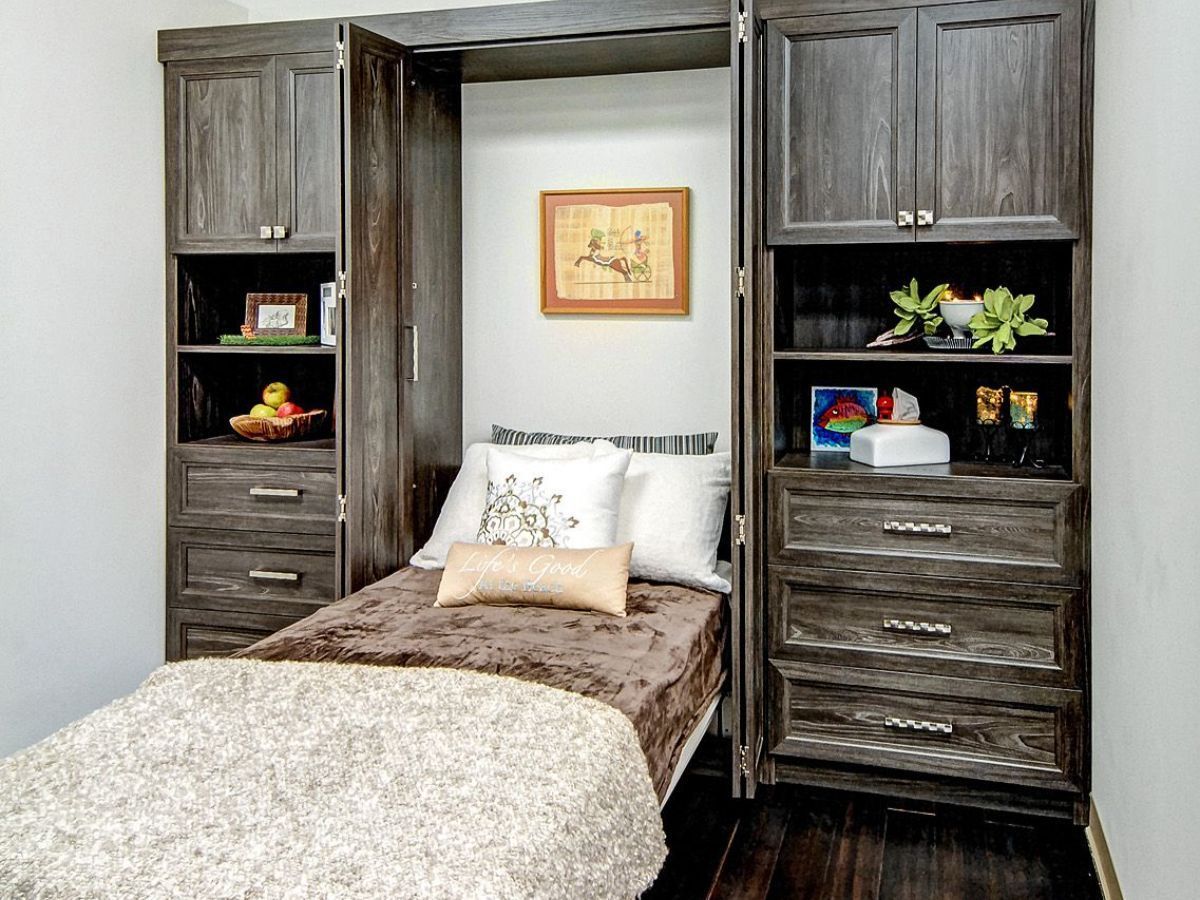 Garage interior with tools organized on pegboards, cabinets, and a workbench.