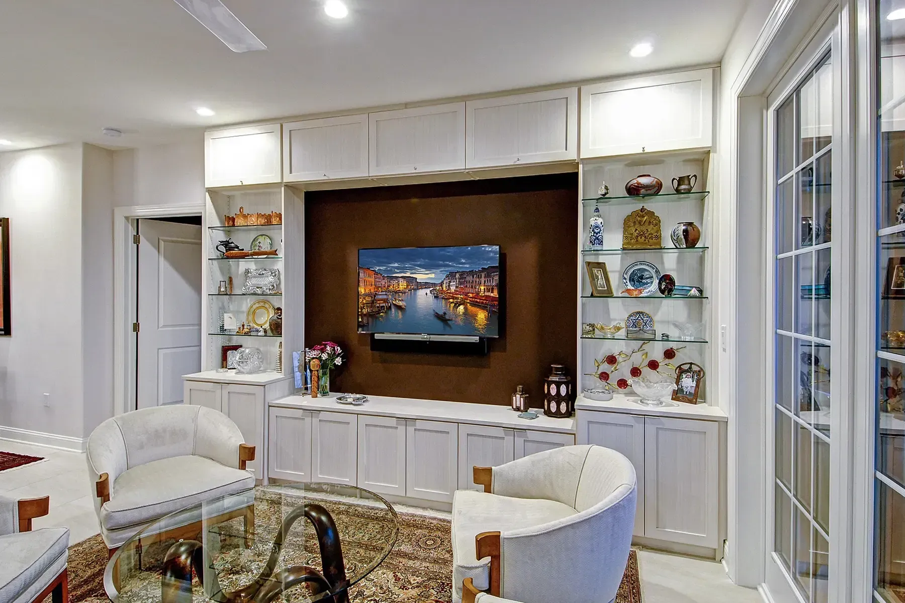 Garage interior with tools organized on pegboards, cabinets, and a workbench.