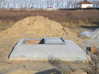 a large pile of dirt is sitting in the middle of a field