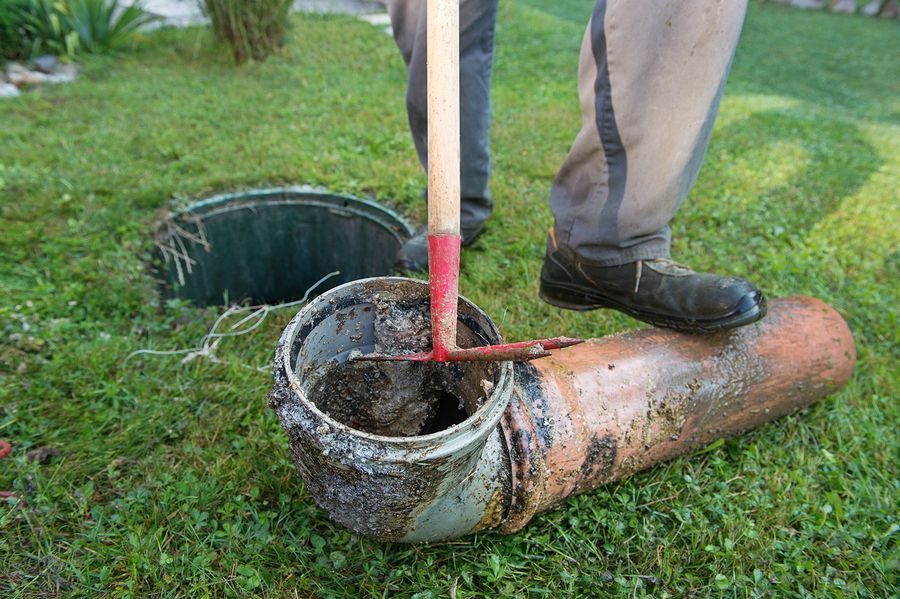 a person is digging a hole in the grass with a shovel