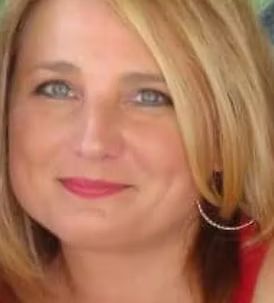 A close up of a woman 's face with blonde hair and earrings.