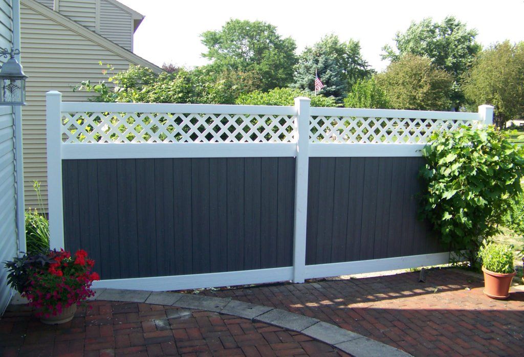 A black and white fence with a lattice top