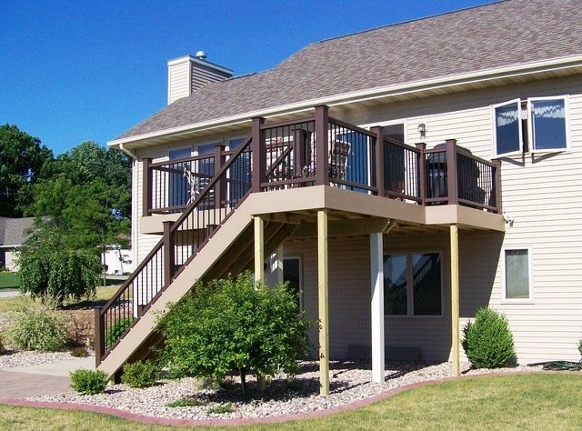 A house with a deck and stairs leading up to it