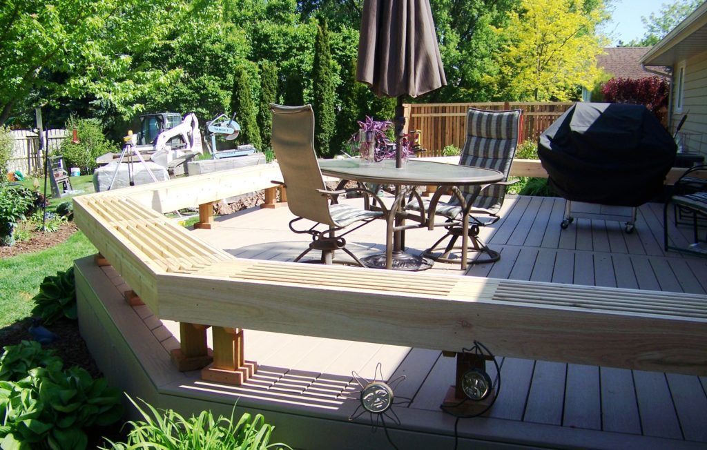 A wooden deck with a table and chairs on it