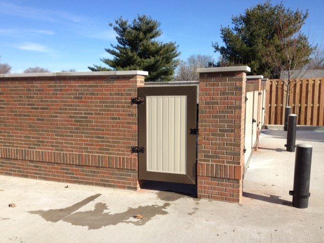A brick wall with a gate in the middle of it