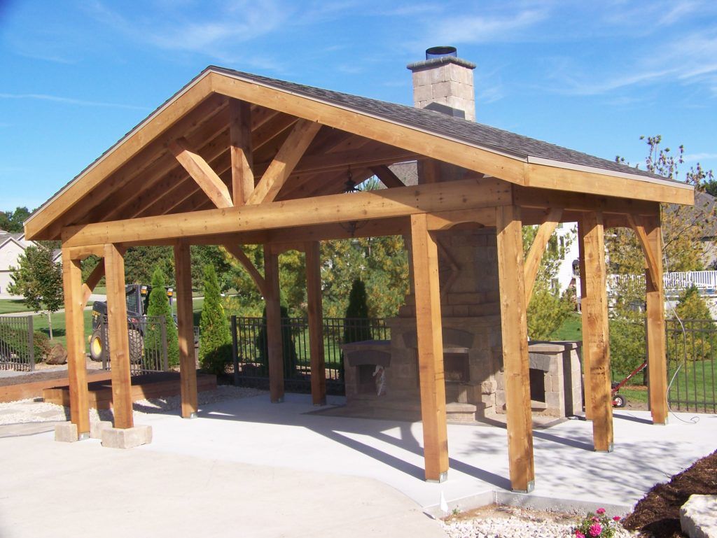 A large wooden pavilion with a fire place