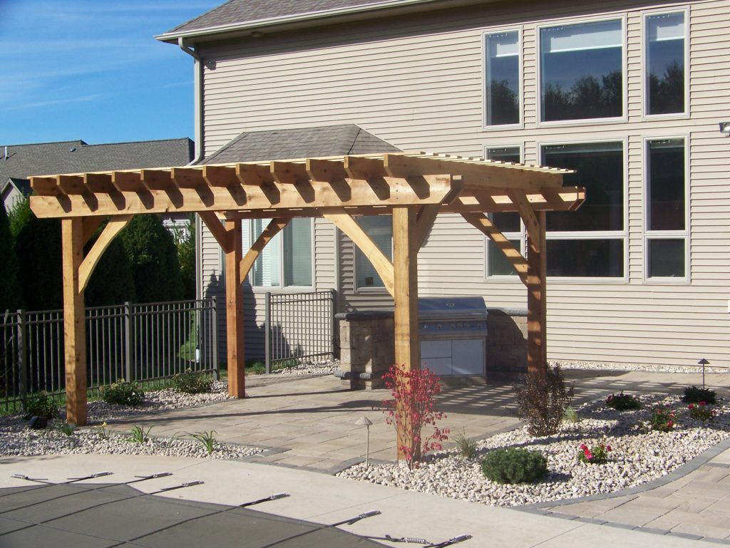 A house with a wooden pergola on the patio